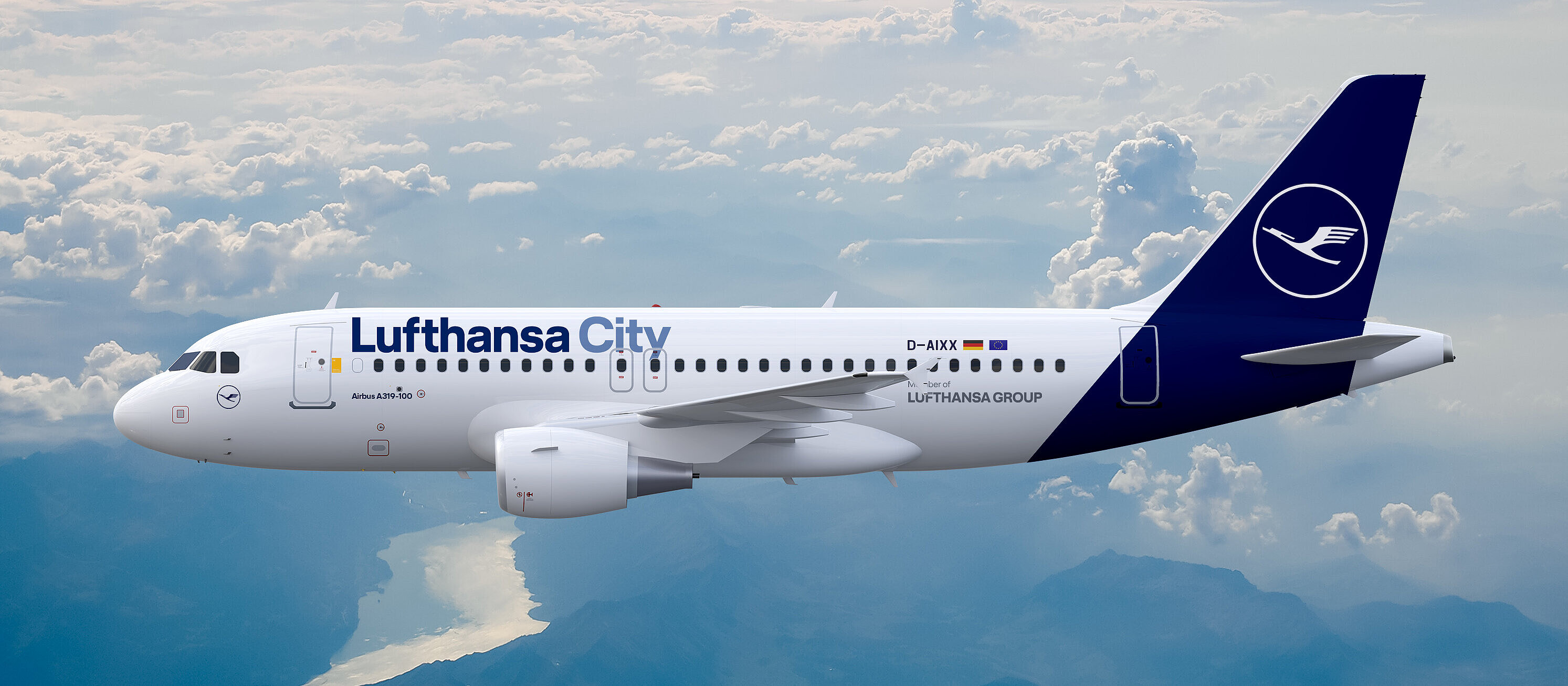 An Airbus A319-100 in flight above the clouds, photographed over a mountain landscape with lake
